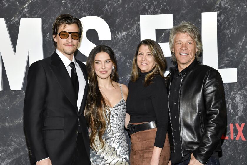 Jake Bongiovi, left, Millie Bobby Brown, Dorothea Bongiovi and Jon Bon Jovi pose together for a group photo at a premiere
