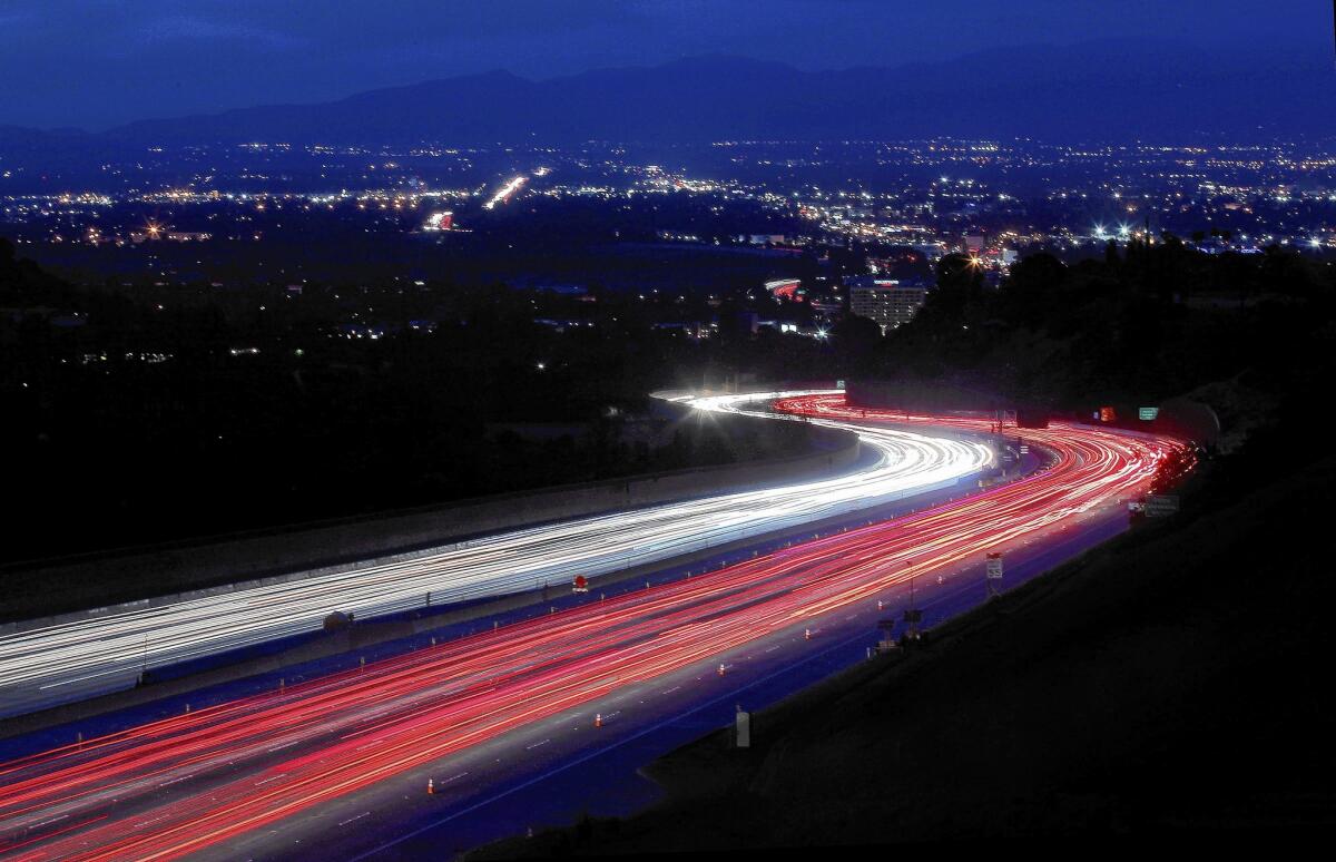 Los Angeles city employees’ commutes intensify traffic, Councilman Bernard C. Parks said. Above, cars stream through the Sepulveda Pass on the 405 Freeway on May 21.