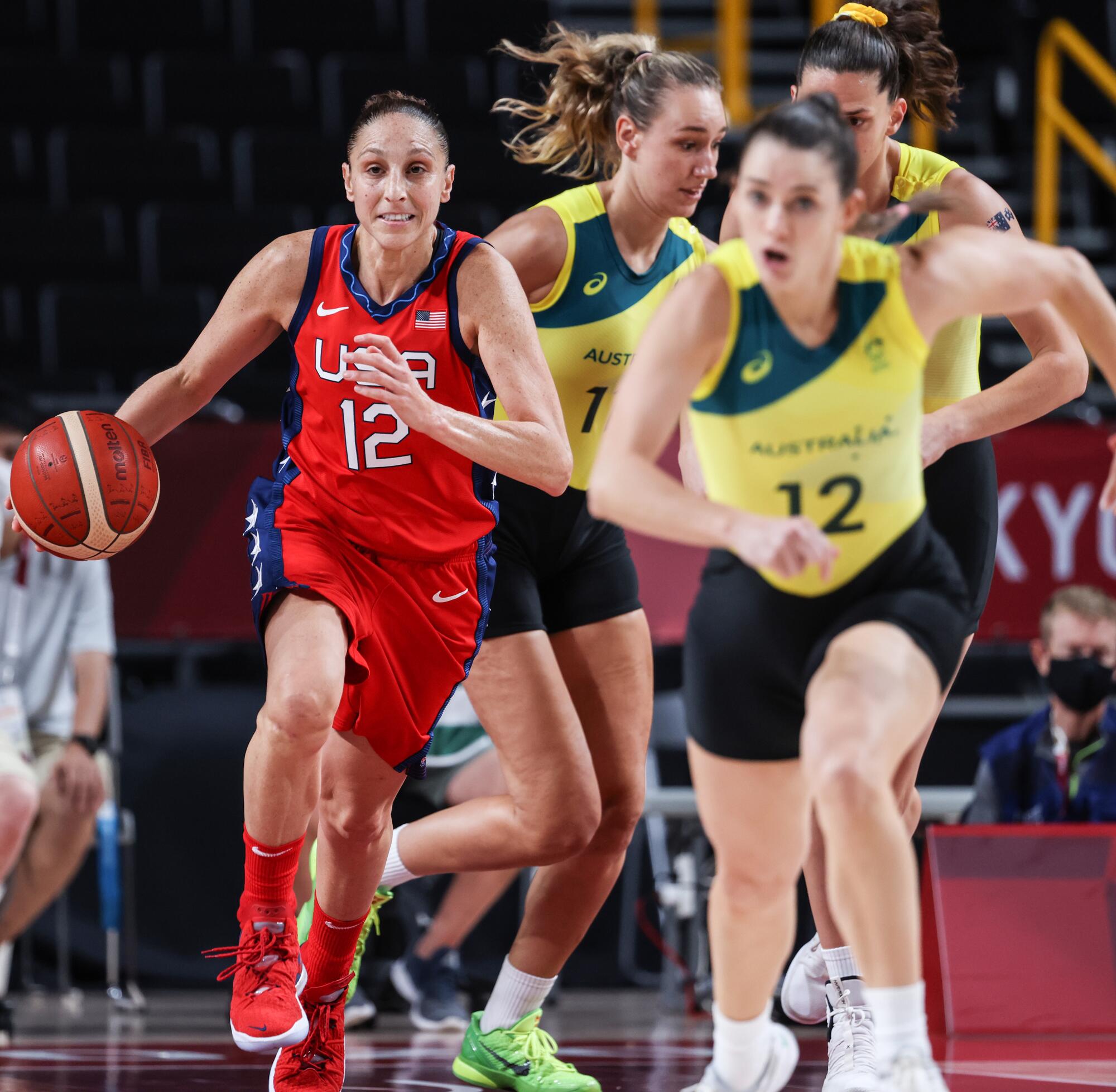 Diana Taurasi runs up the court with the ball during women's basketball at the Tokyo Olympics.