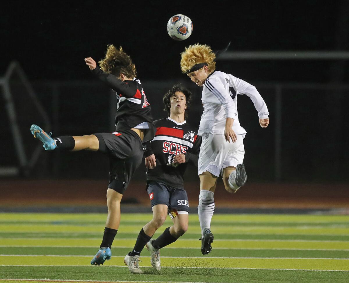 Nico Ruiz (6) right, of Huntington Beach goes up against San Clemente's Niko Kaczmarczyk (10) at midfield.