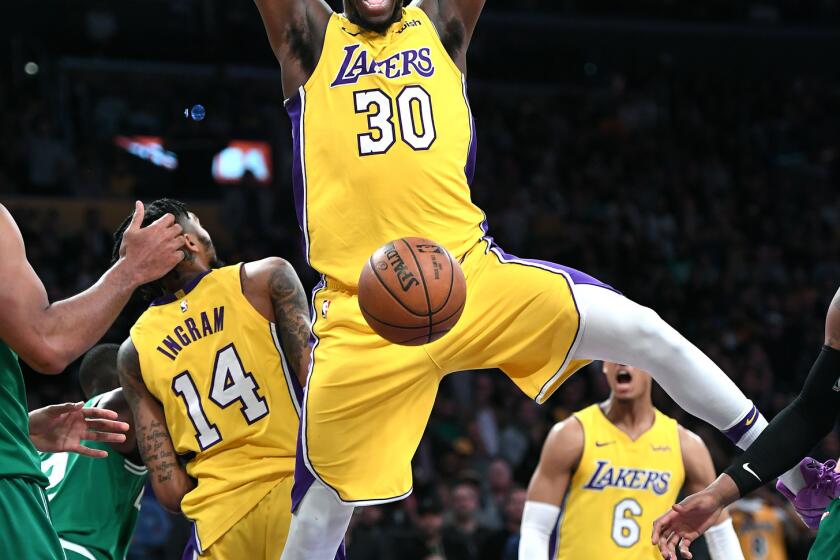 Lakers forward Julius Randle dunks the ball during the fourth quarter of a game Tuesday at Staples Center.