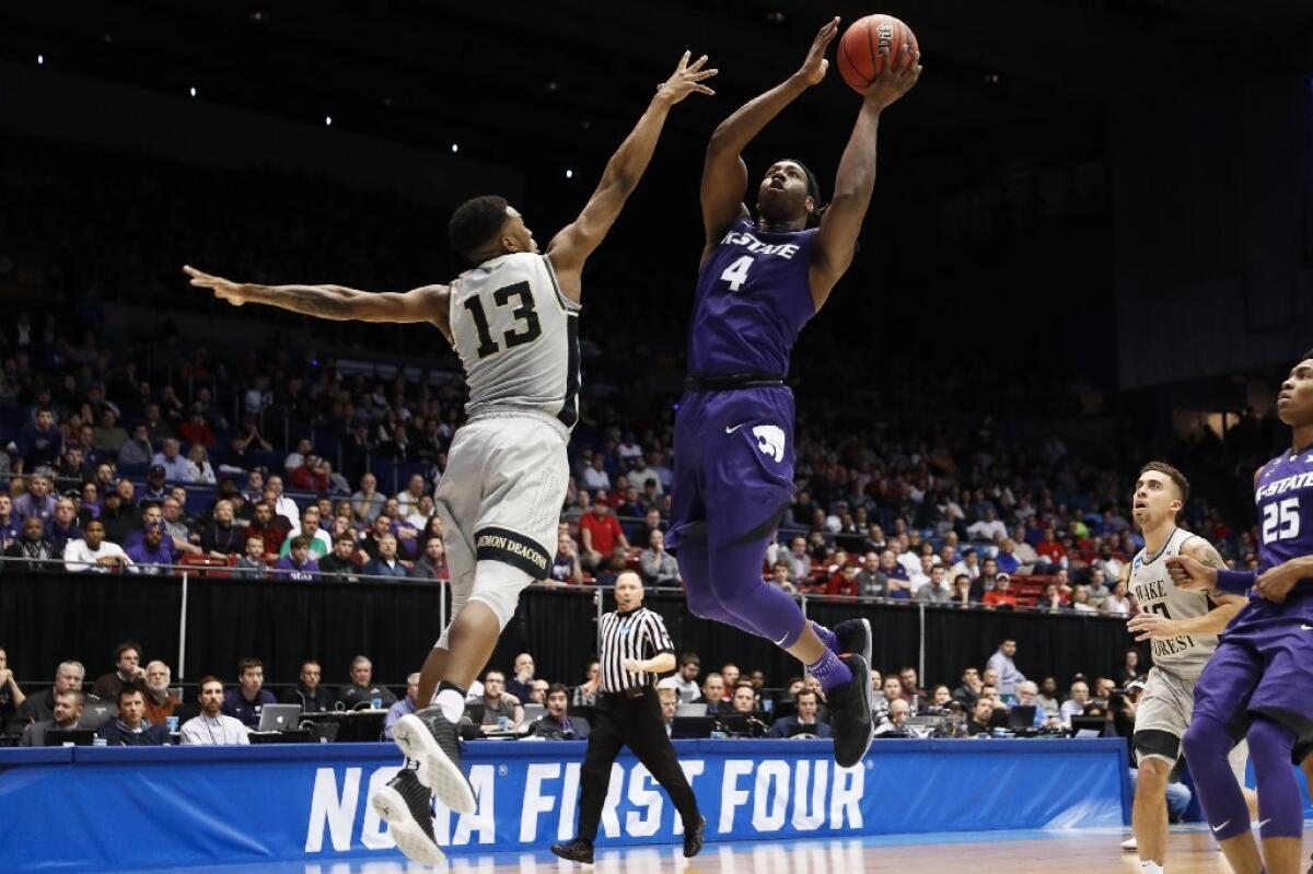 Kansas State's D.J. Johnson (4) shoots against Wake Forest's Bryant Crawford (13) in the second half of a First Four game on Mar. 14.