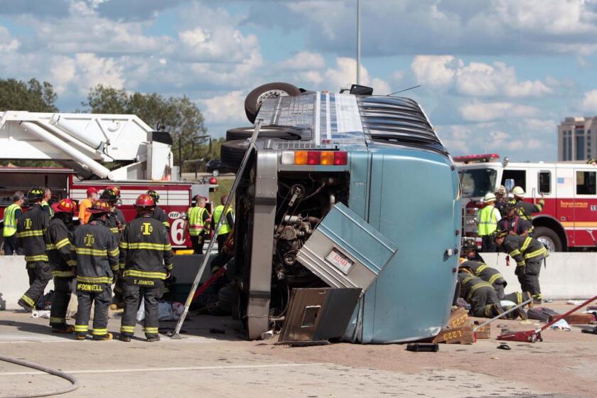 Firefighters work to extricate people trapped after a bus crash in Indianapolis. Three people were killed and 26 hospitalized. The bus was carrying teenagers home from a church camp in Michigan.