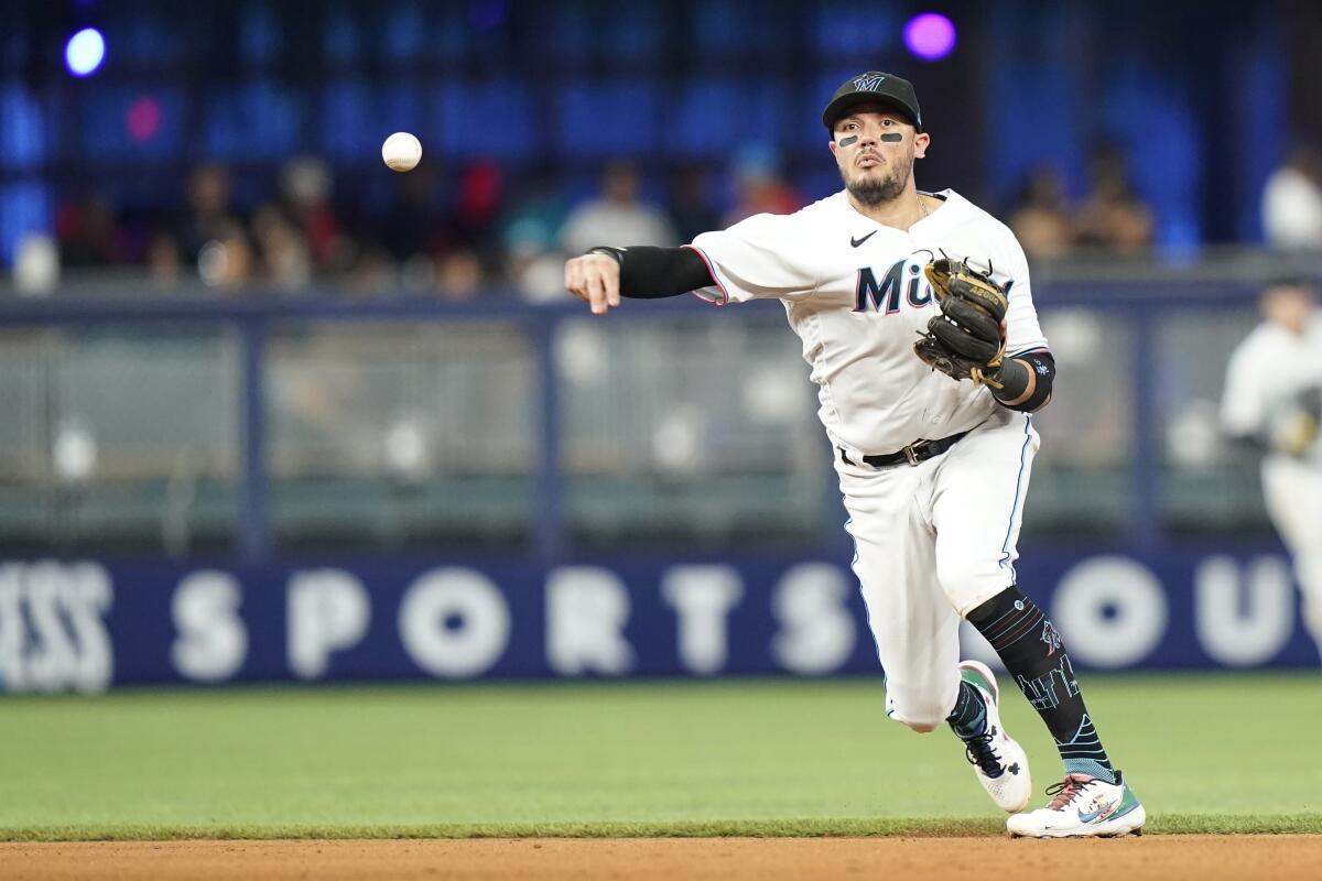 Miami Marlins shortstop Miguel Rojas throws to first in a game against the Washington Nationals.