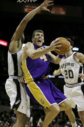 Los Angeles Lakers forward Luke Walton drives to the basket between Spurs defenders Tim Duncan and Manu Ginobili.