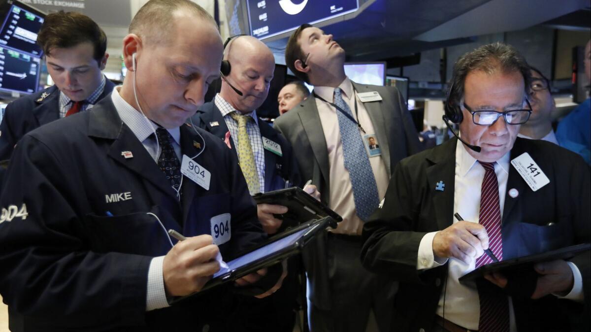 Traders gather on the floor of the New York Stock Exchange on March 22.