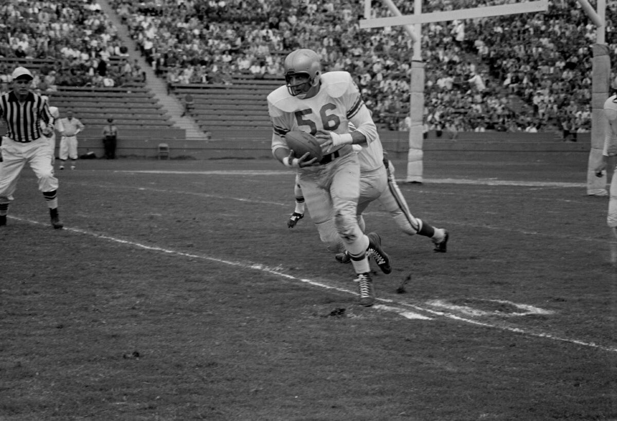 Lions linebacker Joe Schmidt (56) returns a kick against the Rams at the Coliseum in 1958.