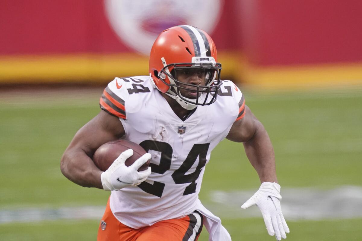 FILE - Cleveland Browns running back Nick Chubb carries the ball during the second half of an NFL divisional round football game against the Kansas City Chiefs in Kansas City, Mo., in this Sunday, Jan. 17, 2021, file photo. Chubb wants to go on a long run with the Browns. Entering the final season of his rookie contract, Chubb, who has rushed for 2,561 yards over the past two seasons and become a fan favorite in Cleveland, said his agent has had talks with the team about a long-term contract extension. (AP Photo/Charlie Riedel, FIle)