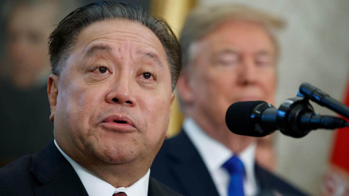 Broadcom CEO Hock Tan, shown with President Trump last November, made a $121-billion offer to take over rival chip maker Qualcomm.