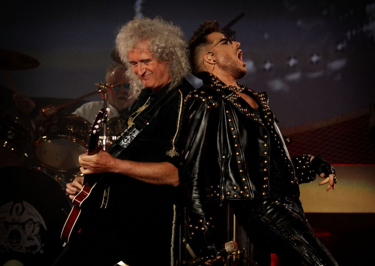 Brian May, left, and Adam Lambert of Queen + Adam Lambert perform in 2014 in Los Angeles.