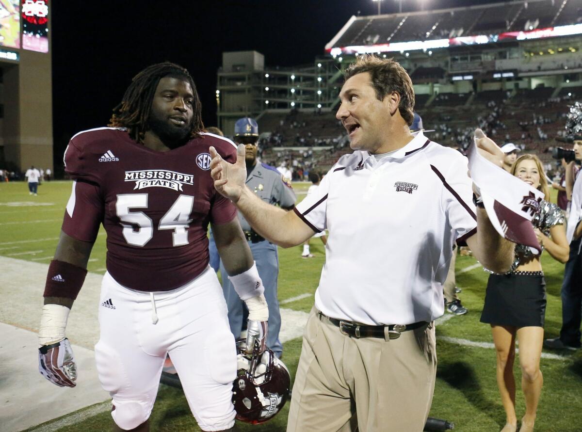 Mississippi State Coach Dan Mullen, right, celebrates with defensive lineman Quay Evans following a 62-7 win over Troy in September.