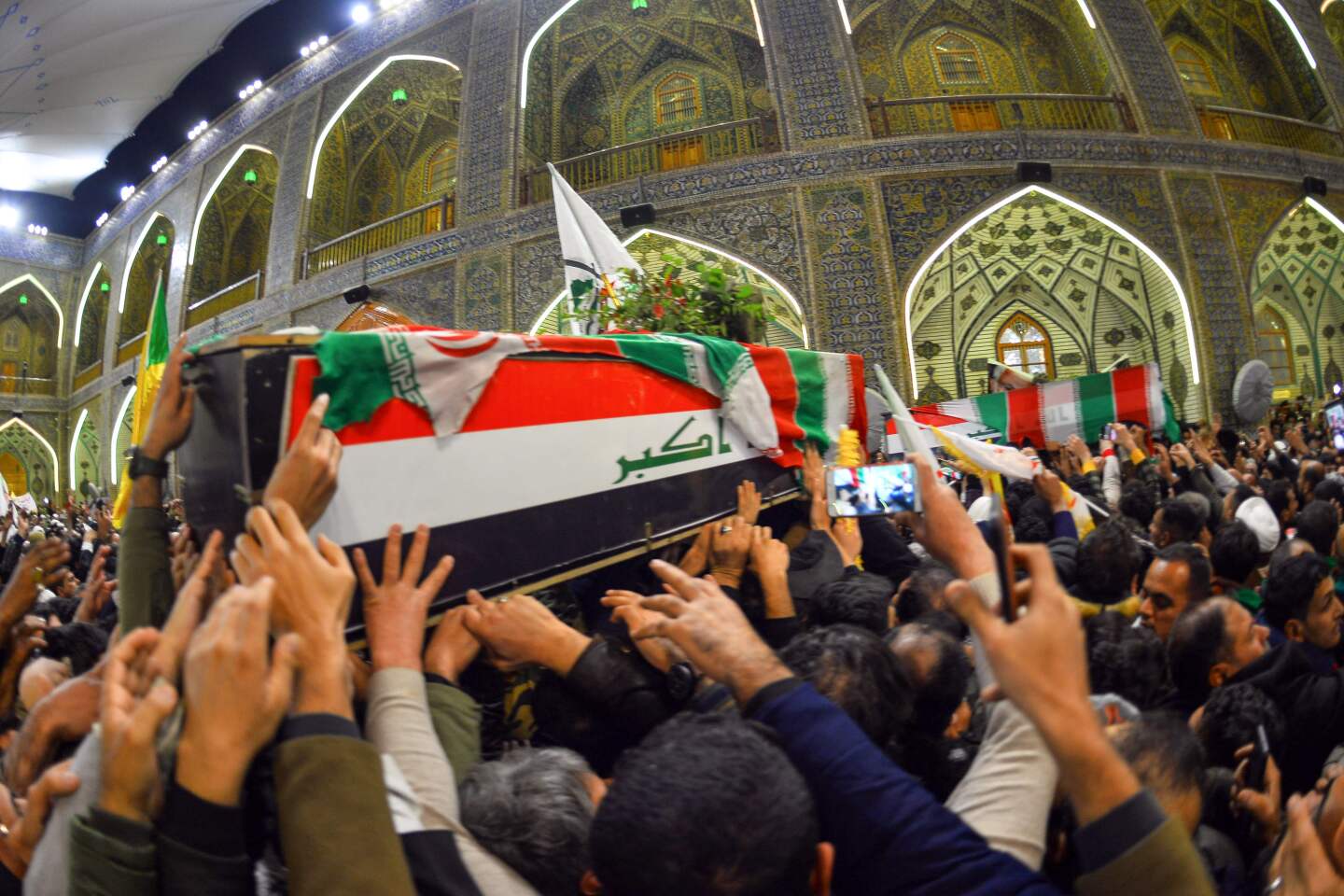 Mourners carry the coffins of slain Iraqi paramilitary chief Abu Mahdi Muhandis, Iranian military commander Qassem Suleimani and eight others Jan. 4 in Najaf, Iraq.