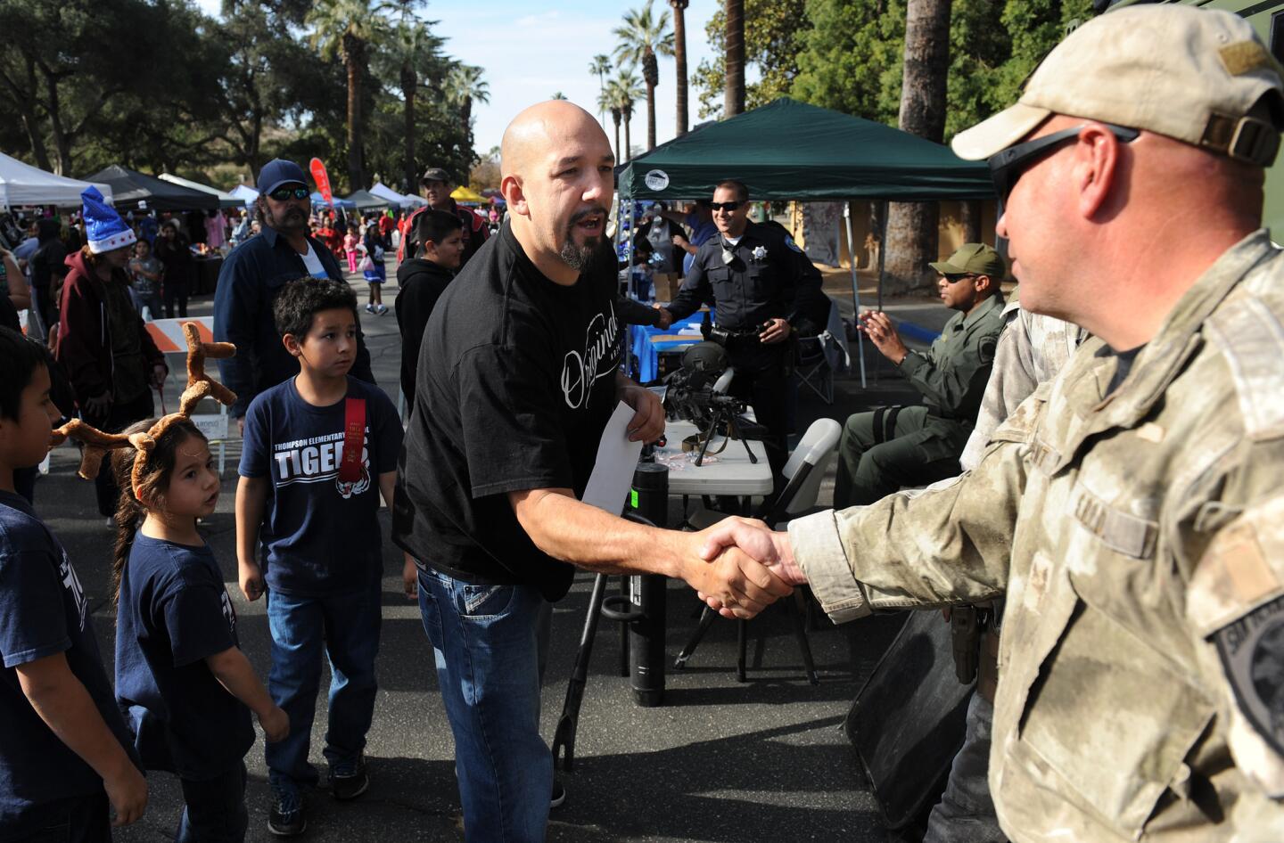 San Bernardino SWAT member Jerry Walent is thanked by a paradegoer in San Bernardino on Saturday.