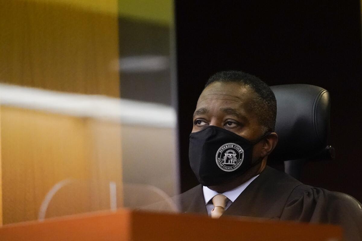 Judge Thomas A. Cox. Jr. listens to a plaintiff in a Fulton County Courthouse