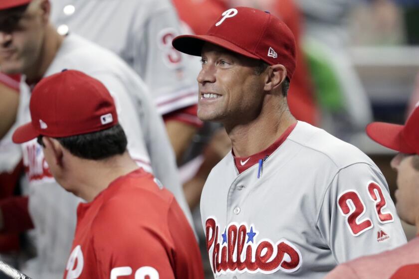 Philadelphia Phillies manager Gabe Kapler (22) watches during the first inning of a baseball game against the Miami Marlins, Friday, July 13, 2018, in Miami. (AP Photo/Lynne Sladky)
