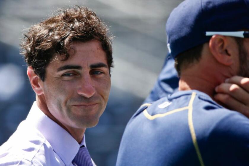 Padres General Manager A.J. Preller watches batting practice before his team's home opener in 2015.