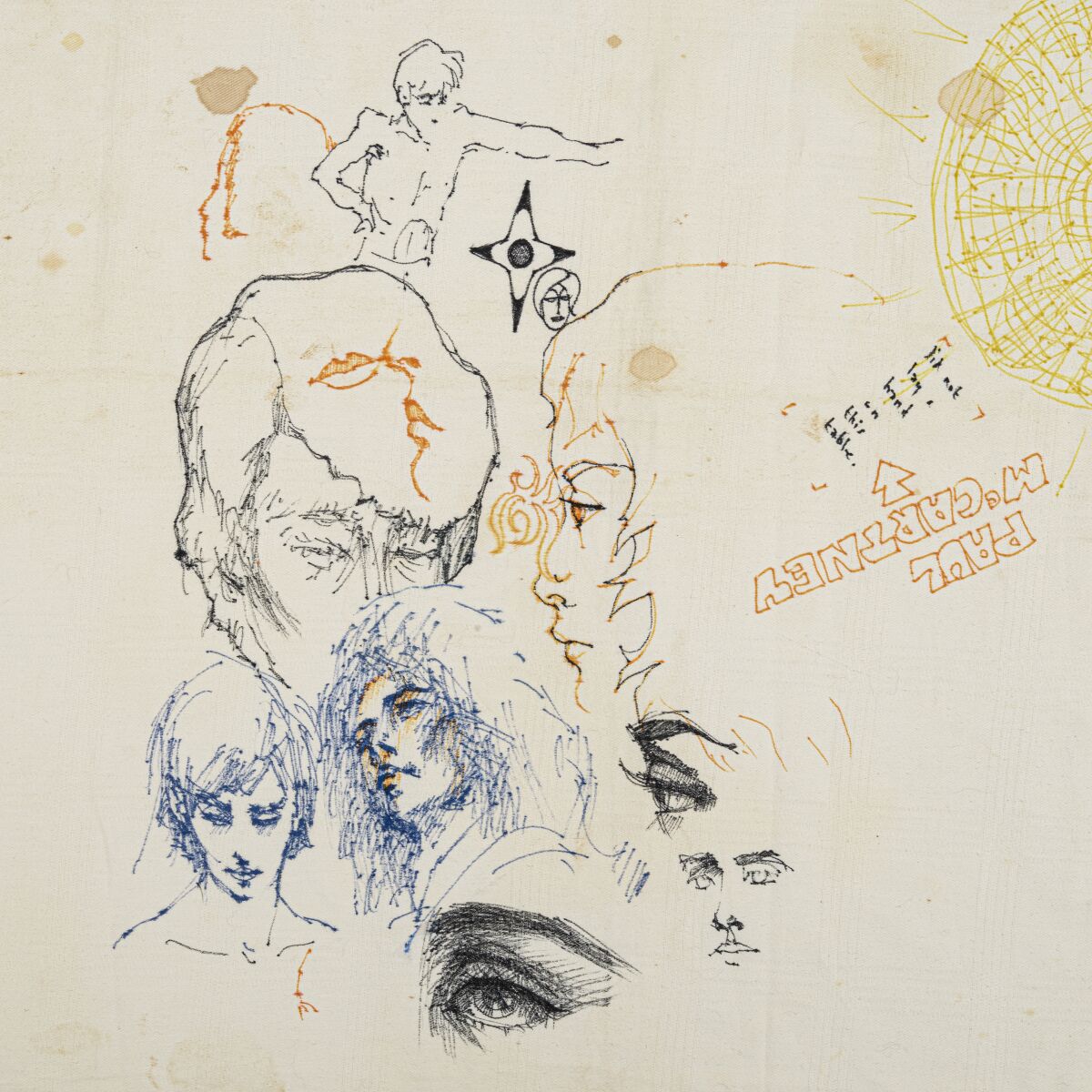 A closeup of a tablecloth with signatures and drawings by the Beatles from 1966.