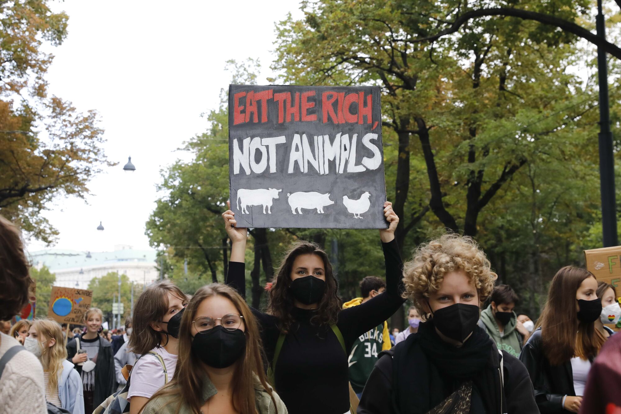A marcher holds a sign that reads, "Eat the rich, not animals."
