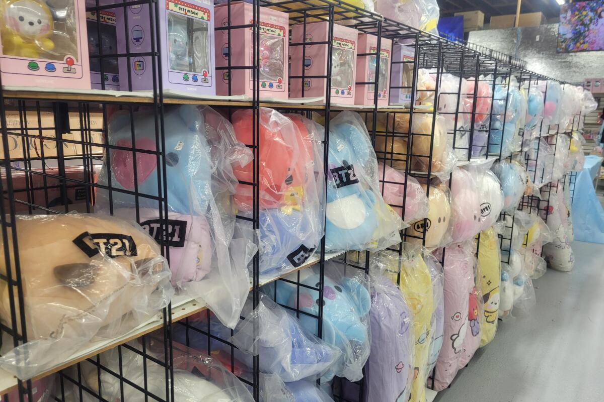 K-pop store with merchandise in wire cubbies.