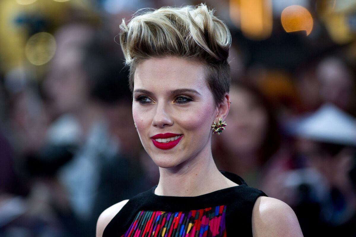 "The Avengers: Age of Ultron" star Scarlett Johansson, seen at the film's London premiere on April 21, dishes on male costars and gets a scare from Chris Evans during her Ellen DeGeneres interview.