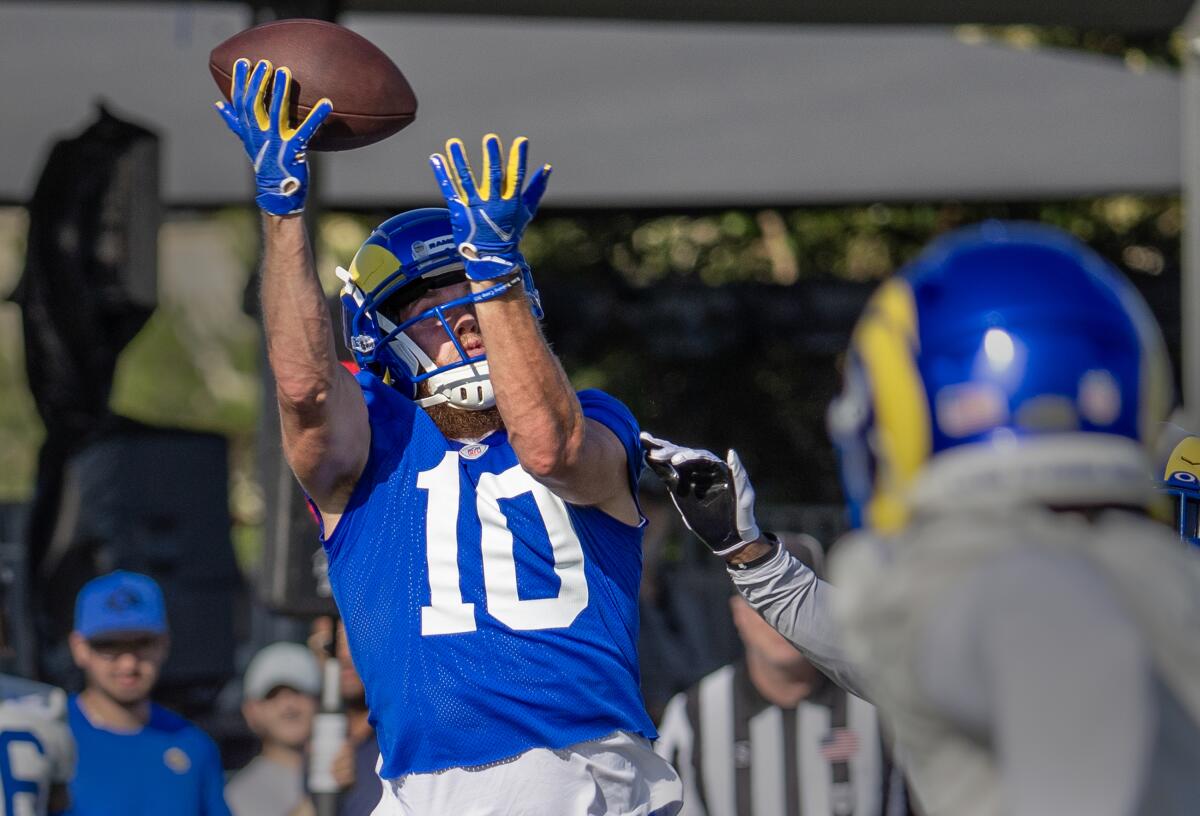Rams receiver Cooper Kupp hauls in a pass during Rams training camp.