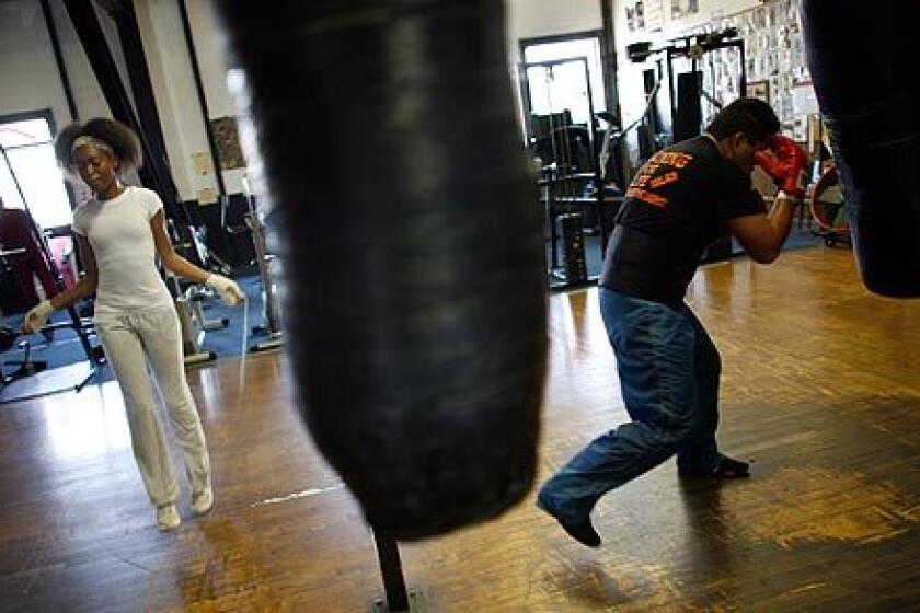 Broadway Gym in Watts has been turning out boxers for more than 30 years. It has seen its ups and downs in the tough neighborhood of South L.A., but like a solid fighter, it has always managed to go the distance. Winter Wyatt, 16, left, skips rope as Alfredo Islas works the heavy bag in the gym. Islas used to box in Mexico and just started hitting the gym after a seven-year absence. More photos >>>