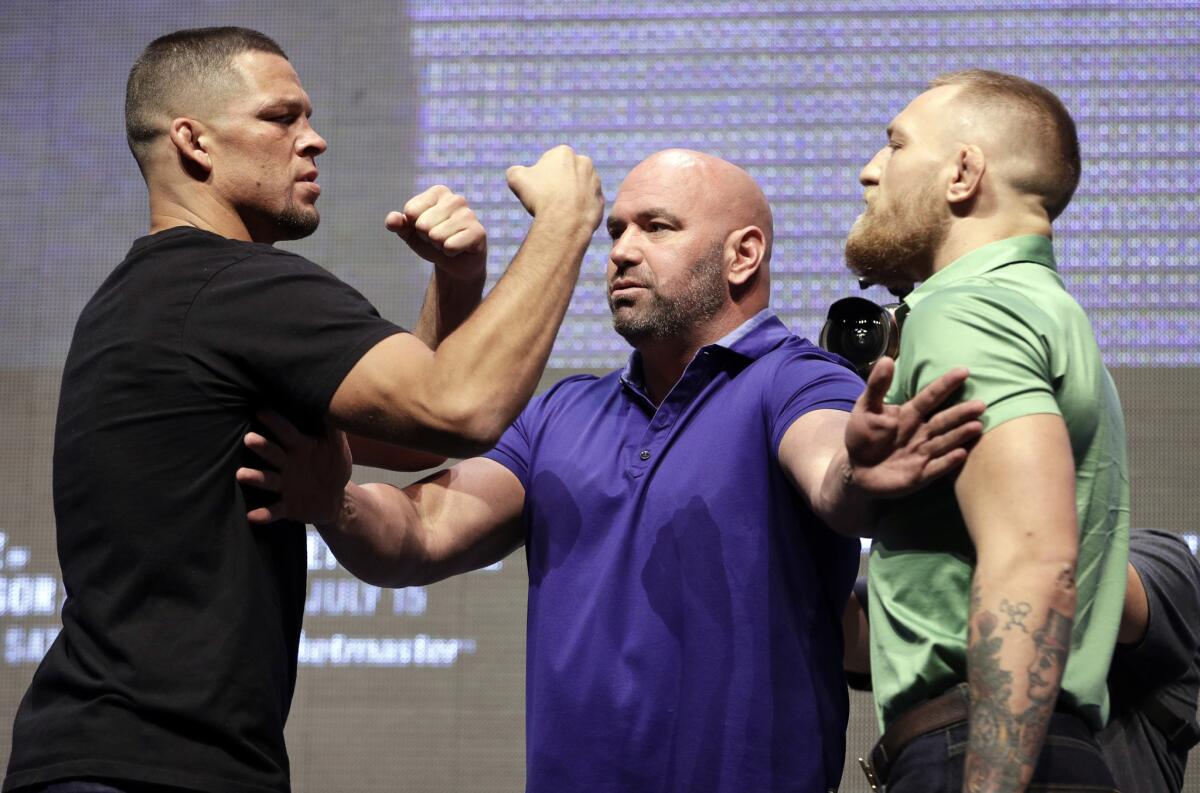 Dana White stands between Nate Diaz, left, and Conor McGregor during a July 7 news conference for UFC 202.
