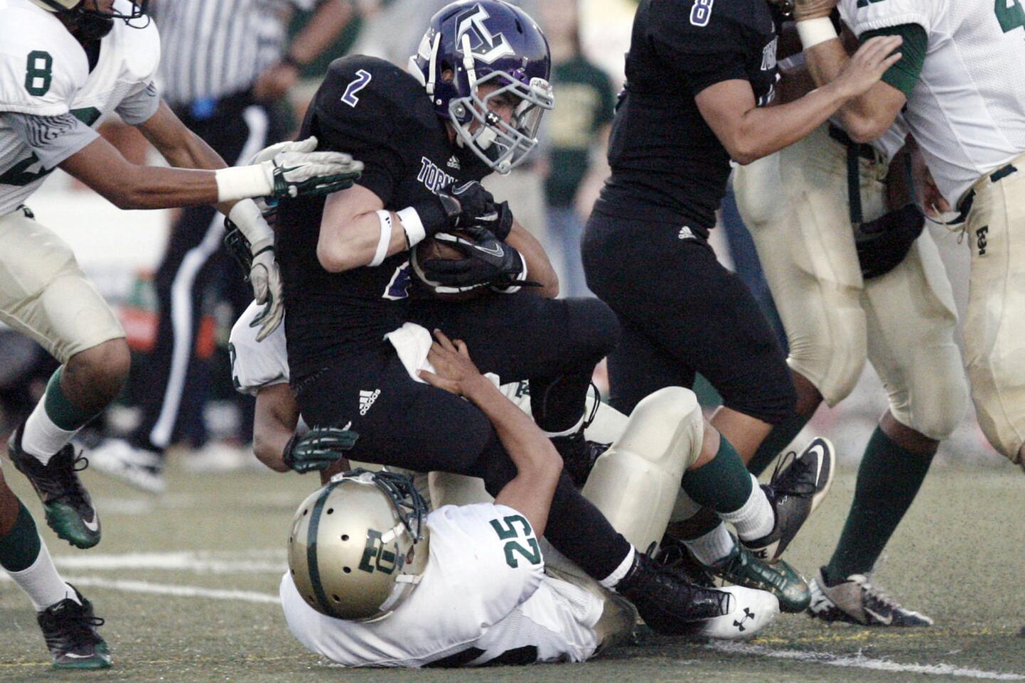 Hoover's Zach Hanson, top, gets tackled by Temple City's Kelvin Li during a game at Glendale High School on Thursday, September 13, 2012.