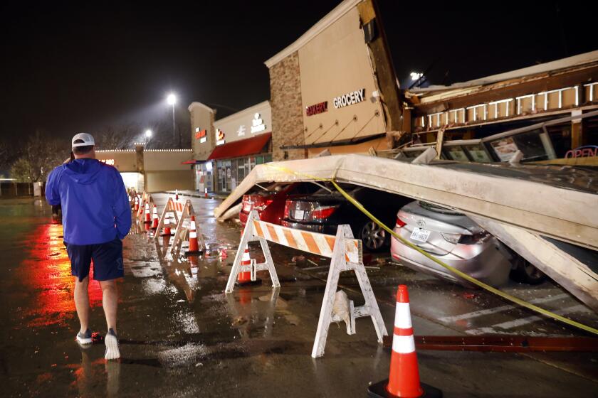 The roof of the La Azteca grocery store on W. Eldorado Parkway peeled off and landed on a half dozen vehicles parked outside as a line of powerful thunderstorms rolled through Little Elm, Texas, on Thursday, March 2, 2023. (Tom Fox/The Dallas Morning News via AP)