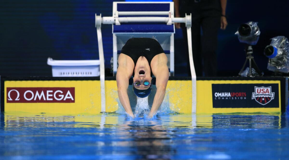 Missy Franklin dives at the start of a preliminary heat in the women's 100-meter backstroke at the U.S. Olympic swimming trials in Omaha.