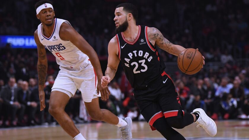 Toronto Raptors' Fred VanVleet (23) drives to the basket past Clippers' Tyrone Wallace (9) during a 123-99 Raptors win at Staples Center on Tuesday.