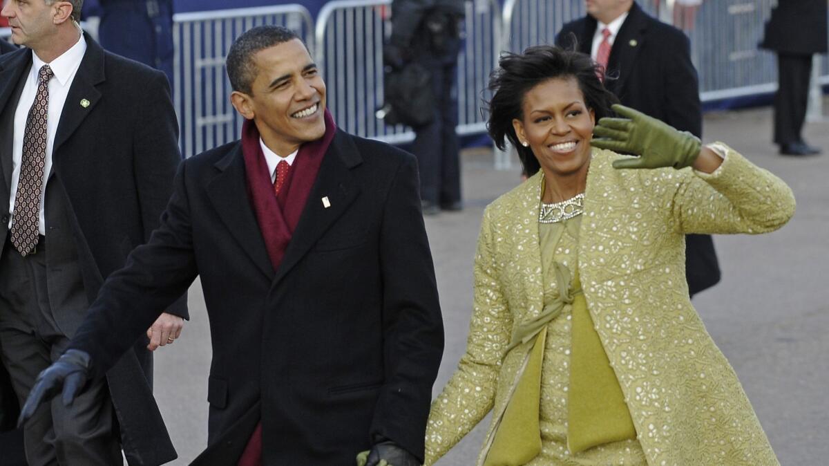 Then-President Obama and Michelle Obama walk the inauguration parade route after his swearing-in in 2009.