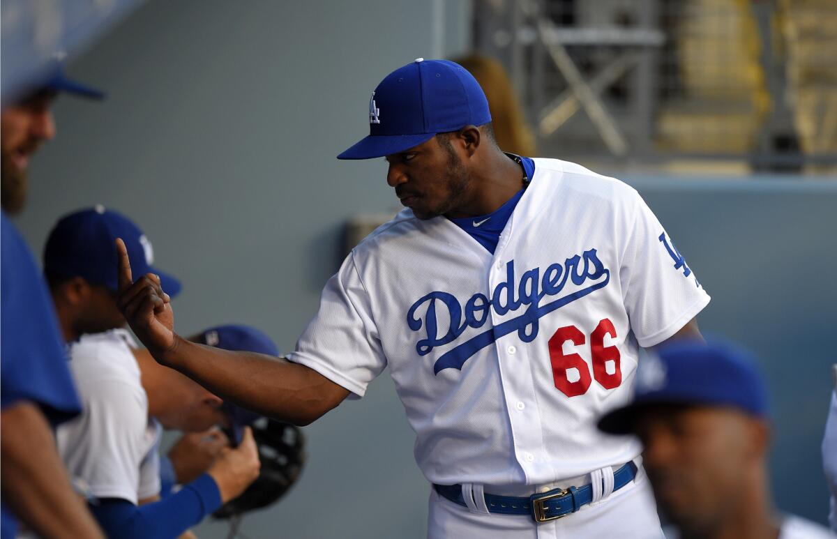 Dodgers outfielder Yasiel Puig is pictured in the dugout before a game Thursday against the Philadelphia Phillies.
