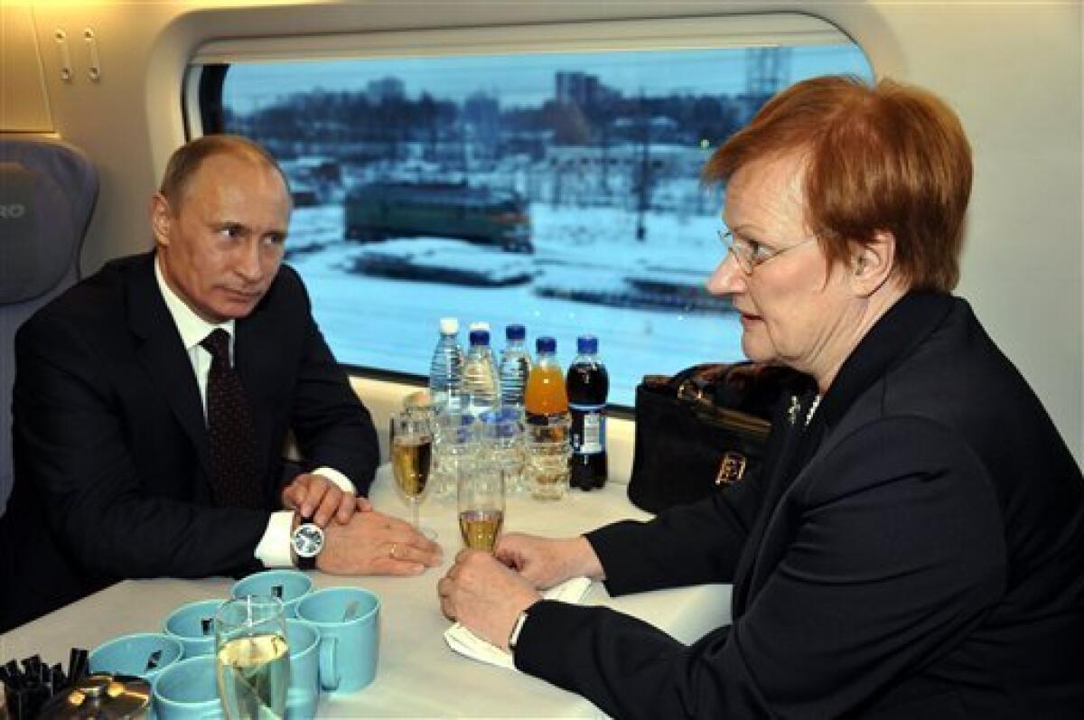 Russian Prime Minister Vladimir Putin, left, and Finnish President Tarja Halonen chat in the Allegro train at the railway station in Vyborg, Russia, some 160 km (100 miles) west of St. Petersburg Sunday Dec. 12, 2010. Halonen and Putin inaugurated the first high-speed rail link between the EU and Russia as new trains start running between Helsinki and St. Petersburg, shortening travel time by nearly half, boosting business travel and tourism. (AP Photo/Lehtikuva/Sari Gustafsson) FINLAND OUT. NO SALES.