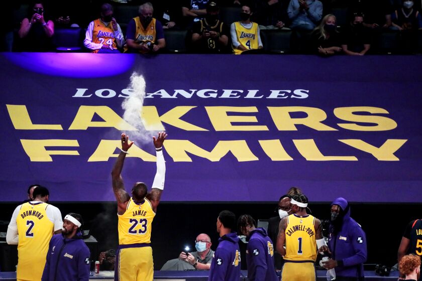 LeBron James throws powder into the air before leading the Lakers to a win over the Golden State Warriors.