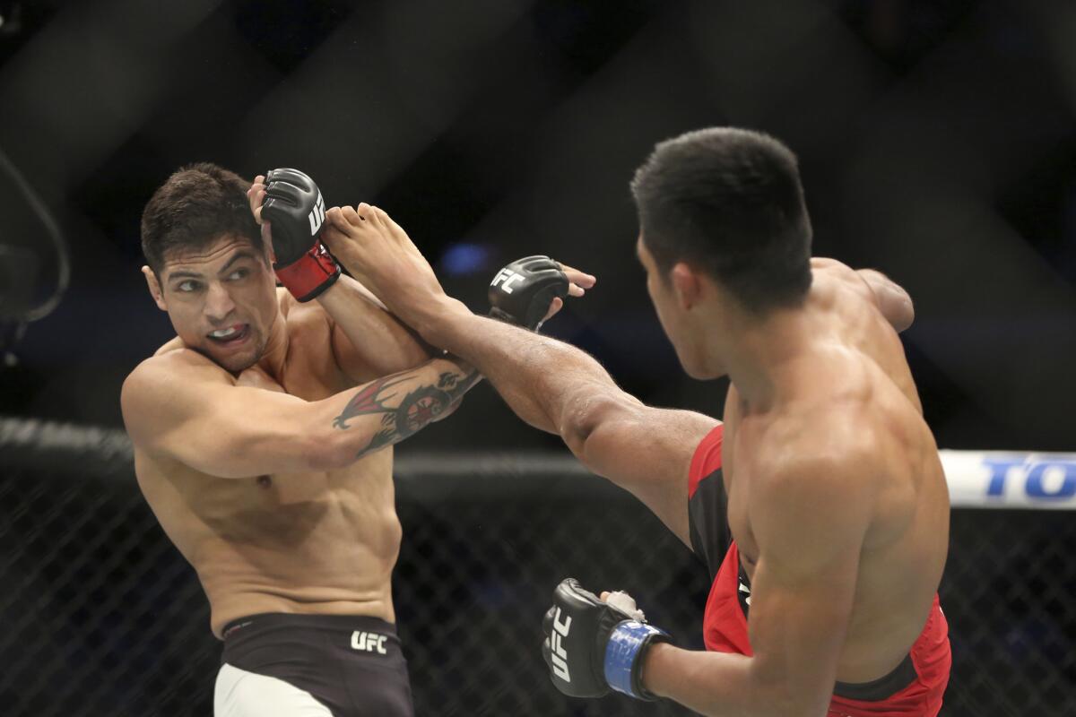 Enrique Barzola attempts a kick against Gabriel Benitez during their fight at UFC 211.