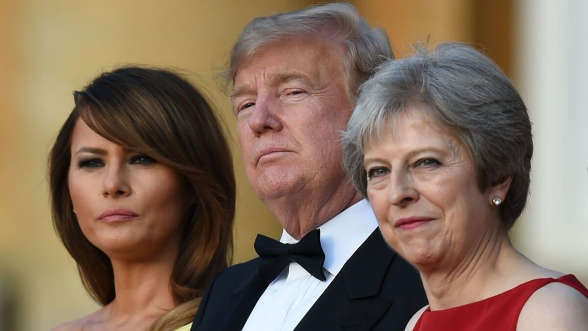 First Lady Melania Trump, left, President Trump and British Prime Minister Theresa May arrive for a black-tie dinner with business leaders at Blenheim Palace, west of London, on July 12, 2018.