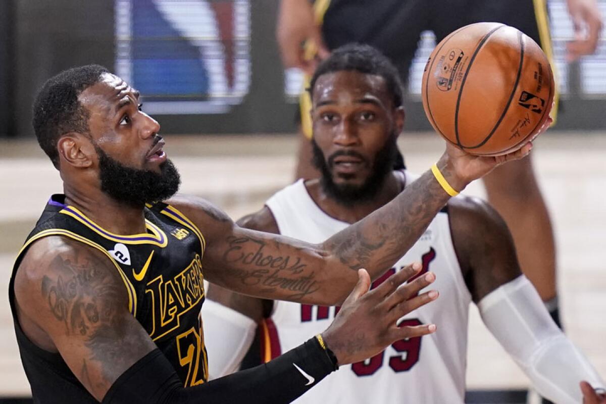 Lakers star LeBron James drives to the basket past Heat forward Jae Croder during Game 5.