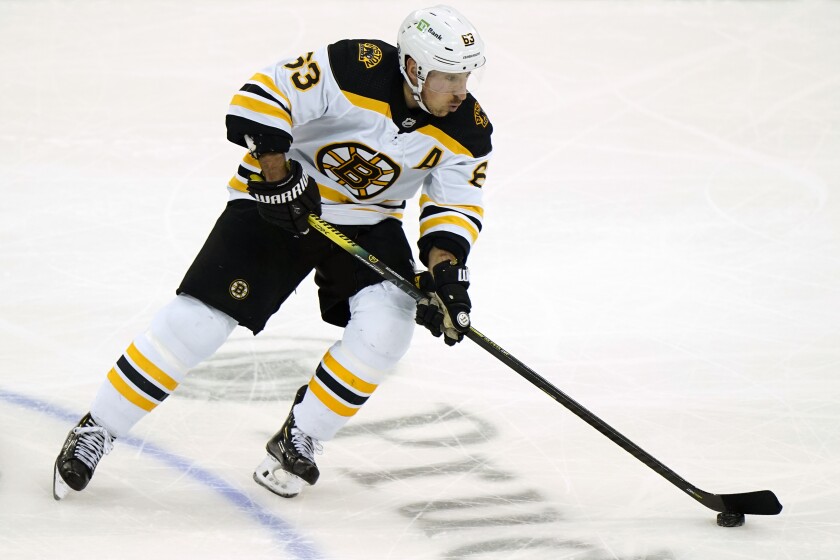 Boston Bruins left wing Brad Marchand (63) skates with the puck during the third period of an NHL hockey game against the New Jersey Devils, Monday, May 3, 2021, in Newark, N.J. Marchand appeared in the 800th game in his NHL career as the Bruins shut out the Devils. (AP Photo/Kathy Willens)