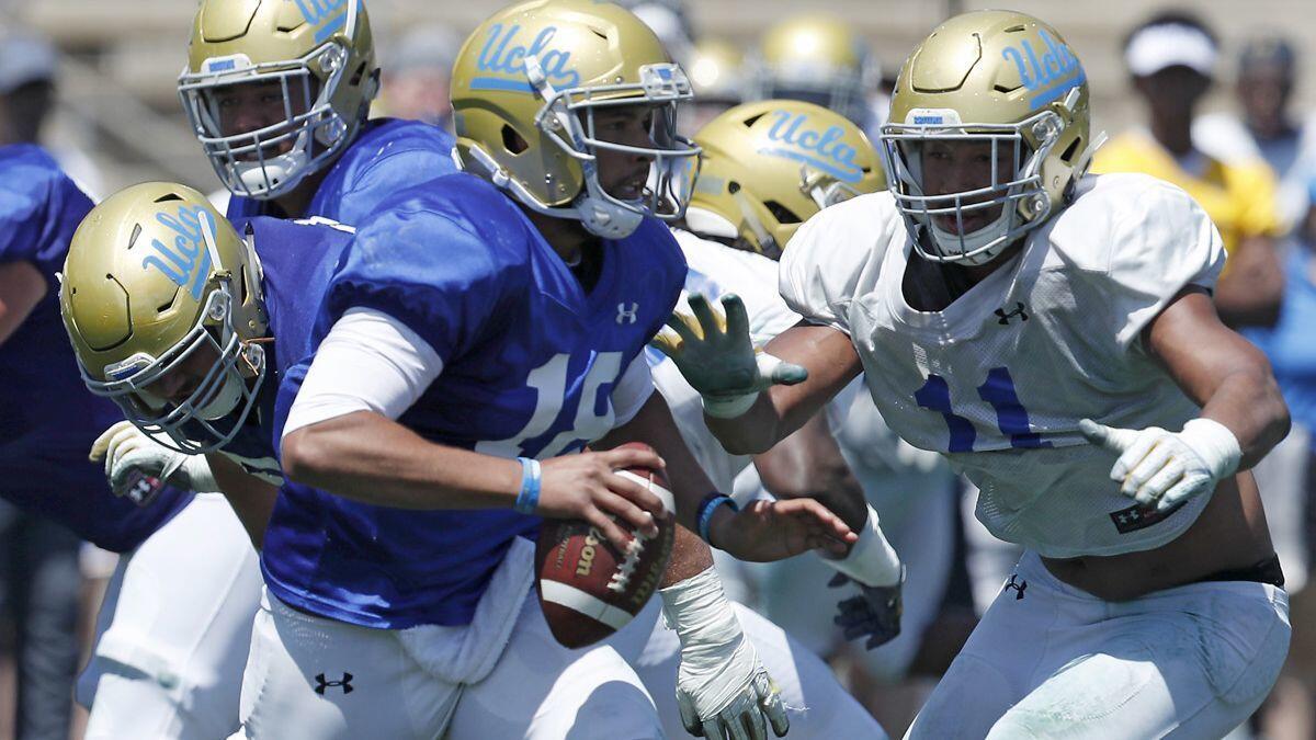 UCLA quarterback Devon Modster gets pressured by defensive back Keisean Lucier-South during the Bruins' spring football game at Drake Stadium on April 21.