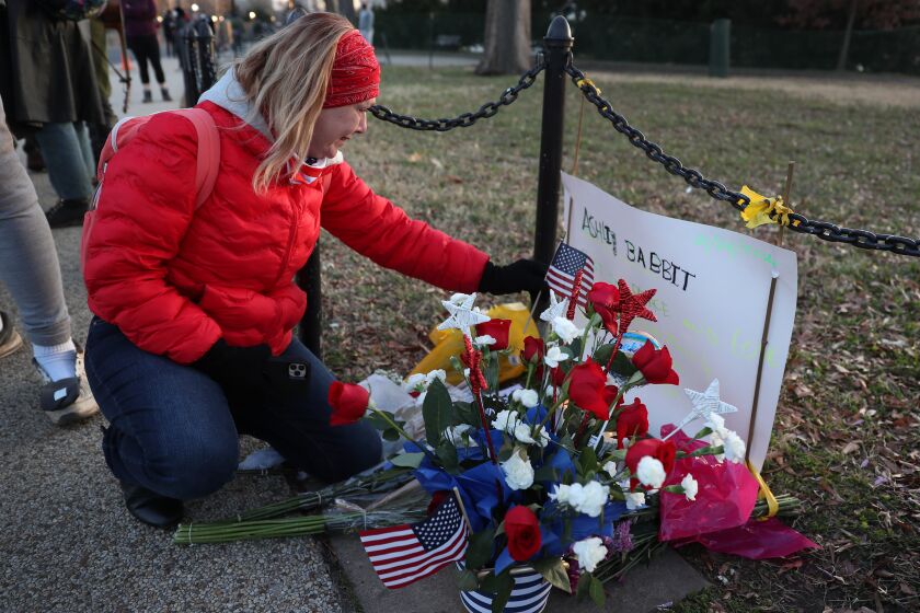 WASHINGTON, DC - JANUARY 07: Melody Black, from Minnesota, becomes emotional as she visits a memorial setup near the U.S. Capitol Building for Ashli Babbitt who was killed in the building after a pro-Trump mob broke in on January 07, 2021 in Washington, DC. Congress finished tallying the Electoral College votes and Joe Biden was certified as the winner of the 2020 presidential election. (Photo by Joe Raedle/Getty Images)