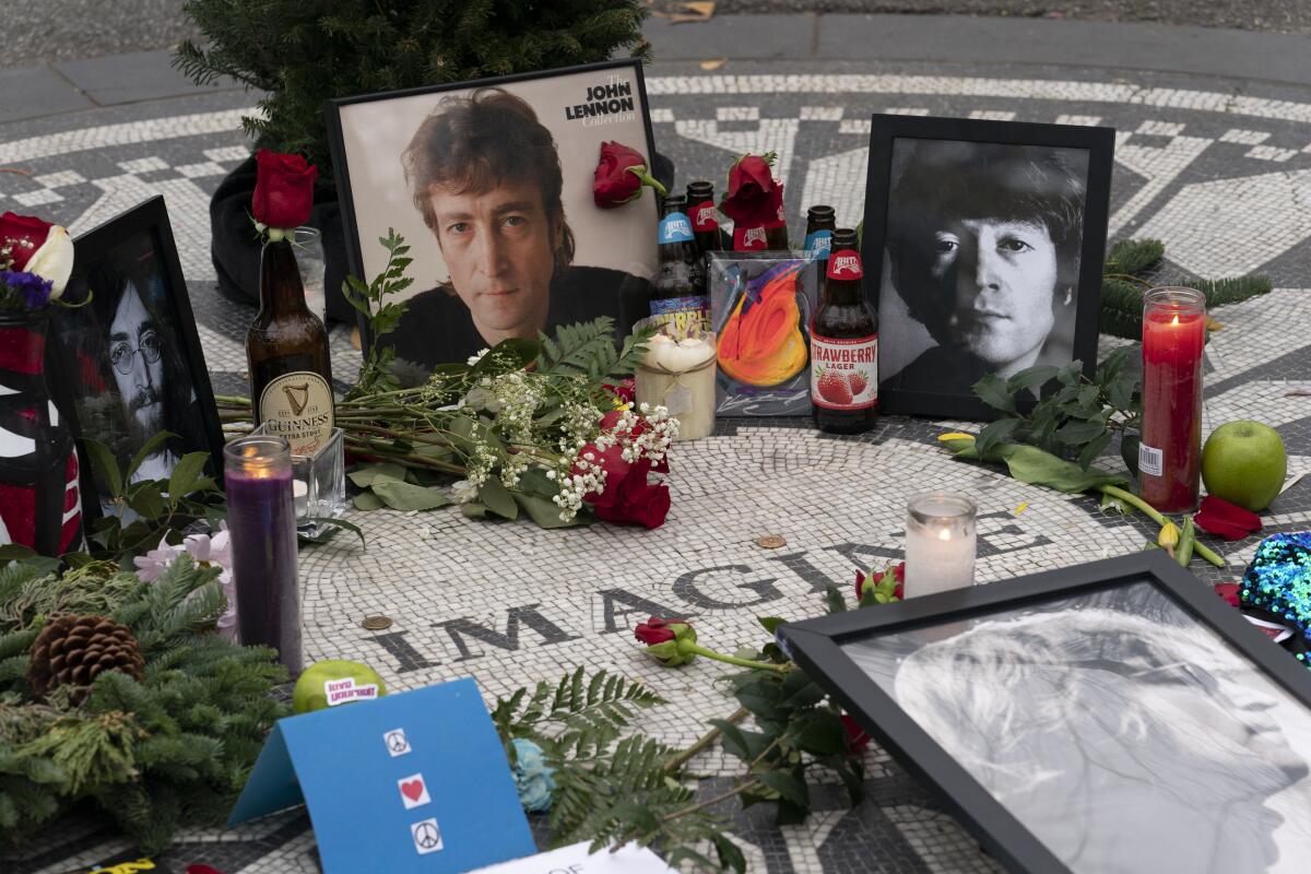 Photos, flowers and candles left at Strawberry Fields in New York's Central Park to remember John Lennon