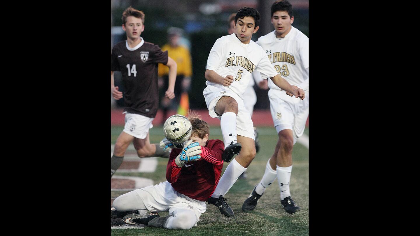 St. Francis' Mateo Ramirez tries for a goal past Crespi goalie Matthew Lipire during a game on Monday, January 25, 2016.