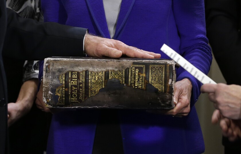 Joe Biden places his hand on the Biden family Bible as he takes the oath of office as vice president in 2013.