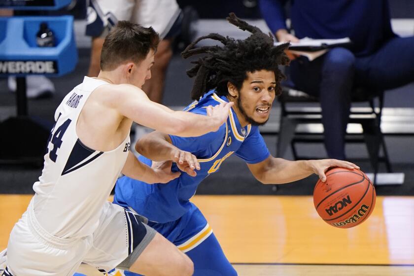 UCLA guard Tyger Campbell (10) drives past BYU guard Connor Harding (44) during the second half of a first-round game in the NCAA college basketball tournament at Hinkle Fieldhouse in Indianapolis, Saturday, March 20, 2021. (AP Photo/AJ Mast)