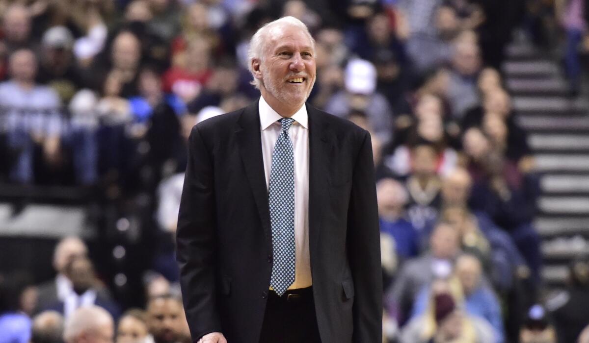San Antonio Spurs coach Gregg Popovich smiles during a game against the Toronto Raptors in February.