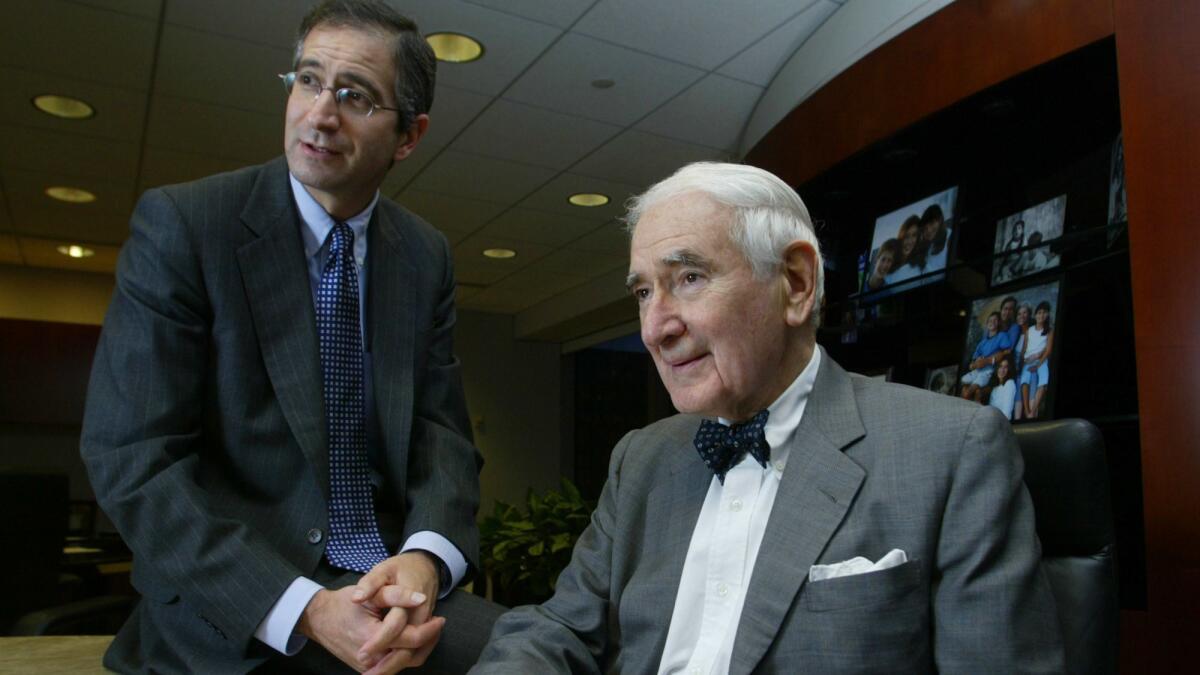 Brian Roberts, left, then-president of Comcast, with his father, Ralph Roberts, then-chairman, after the purchase of AT&T Broadband in 2002.