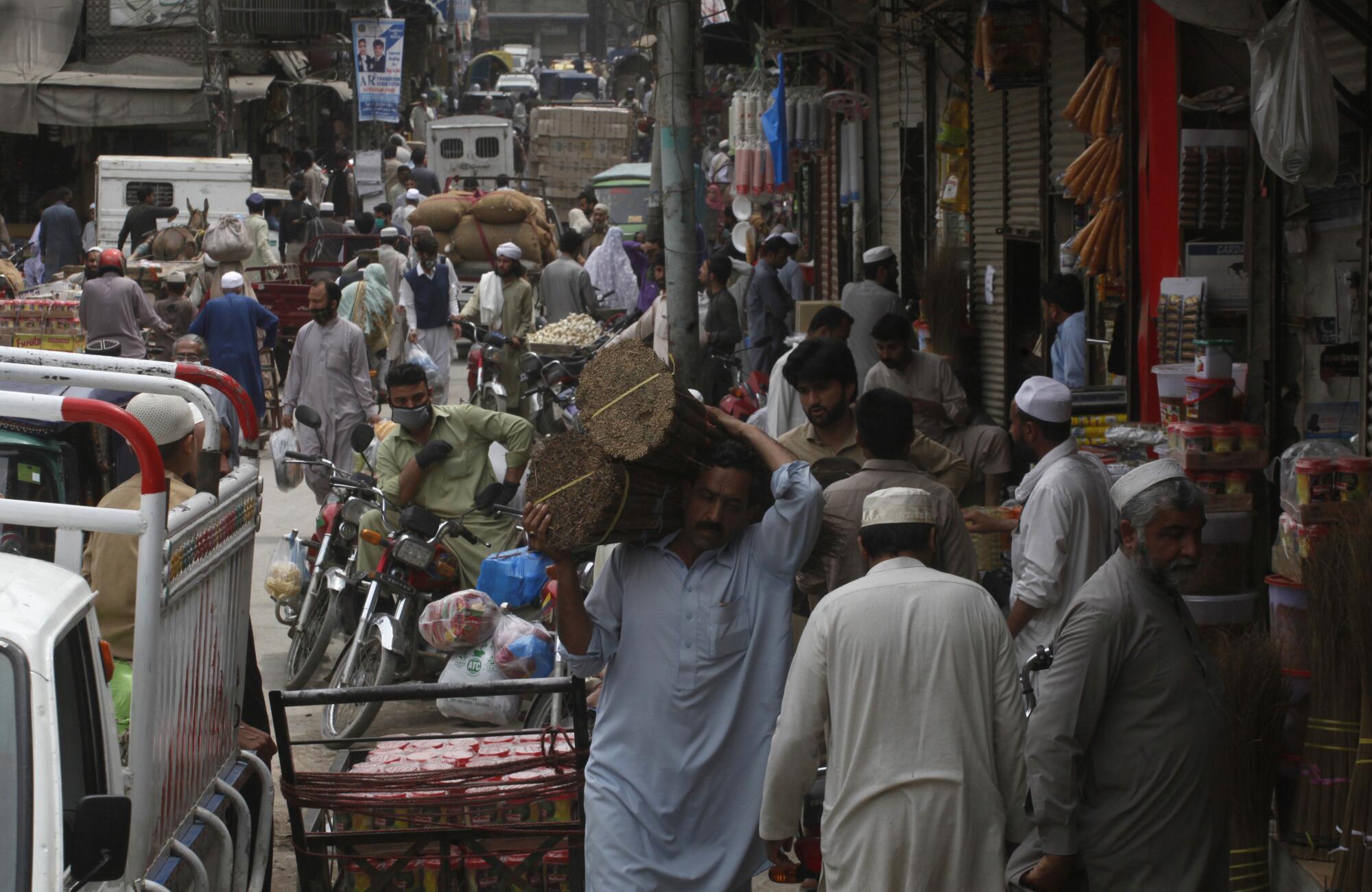 People buy groceries in Peshawar, Pakistan, in April.