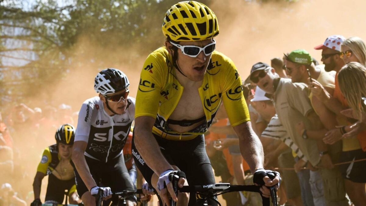 Geraint Thomas, wearing the overall leader's yellow jersey, and Sky teammate Christopher Froome ride through the "Dutch corner" on July 19.