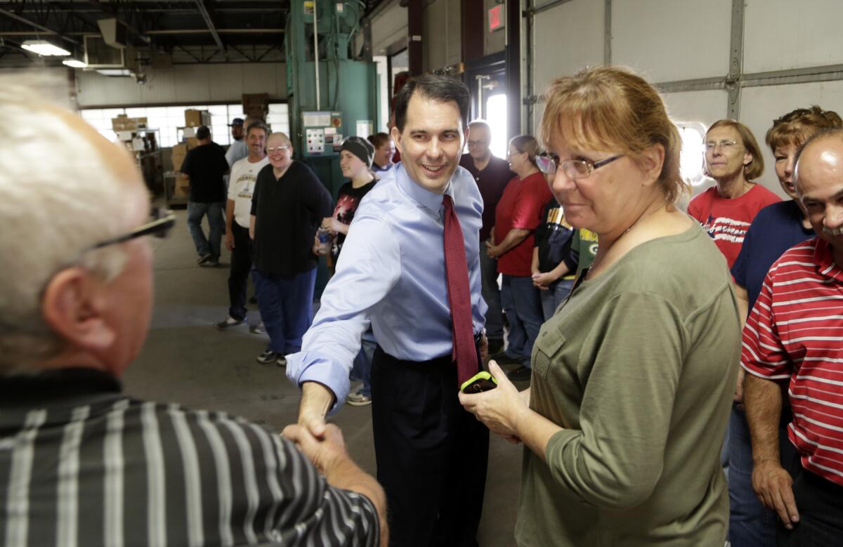 Republican Gov. Scott Walker of Wisconsin campaigned last week at a manufacturing company in Racine. Walker holds a narrow lead over Democrat Mary Burke as he seeks a second term.